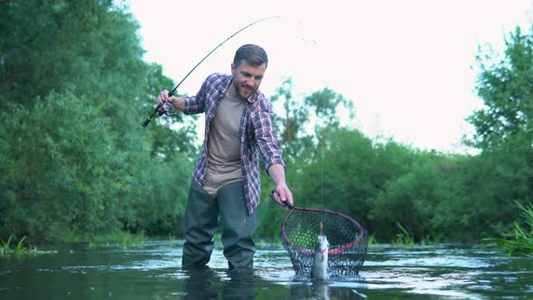 Fisherman with Fishing Rod on the River