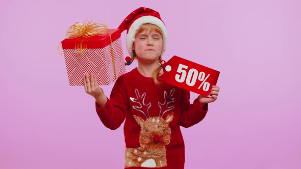 Child Girl in Christmas Hat Showing Gift Box and 50 Percent Discount Inscriptions Banner Text Note