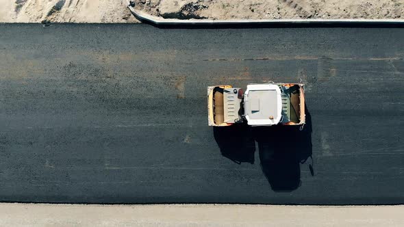 Asphalt Spreader in Motion in a Top View