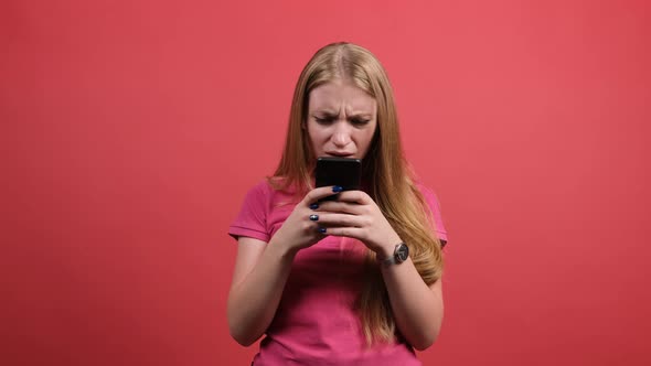 Portrait of a Surprised Confused Woman Chatting Online with Friends.