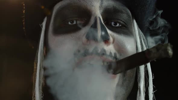 Close Up Shot of Creepy Man Face with Skeleton Makeup Smoking Cigar, Making Faces, Looking at Camera