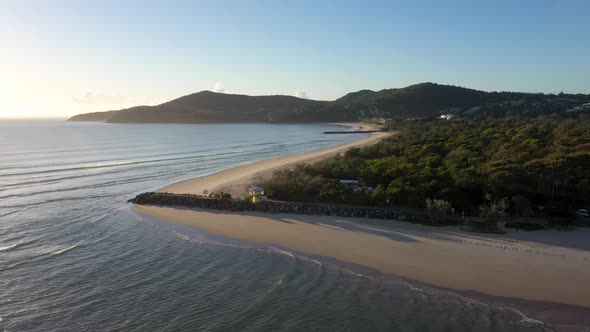 Noosa Heads sunrise aerial with beach, river mouth, waves. Sunshine Coast, Queensland