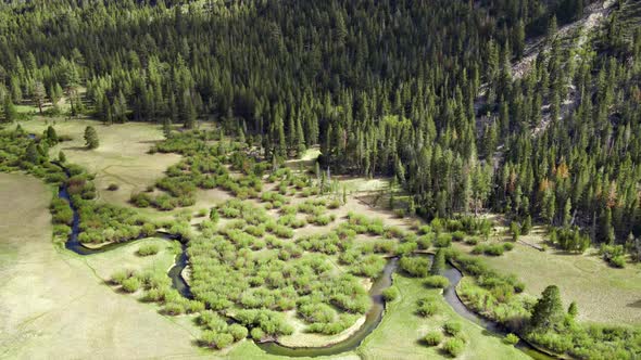 Aerial Of A Winding River Through A Meadow