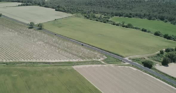 Aerial View of Green Fields and Dry Surrounded By Hills Plants and Mountains