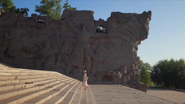 Young tourist climbing the steps at the Memorial Complex in Volgograd