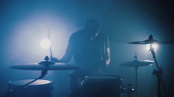 Silhouette of Professional Drummer Plays a Drums in Smoky Studio Slow Motion