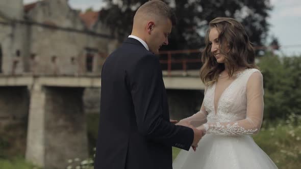 Caucasian Groom with Bride Near Old Castle. Wedding Couple. Happy Newlyweds