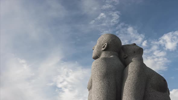 Granite Sculpture Of A Man And Woman Sitting Back to Back At Vigeland Park In Frogner Park, Oslo, No