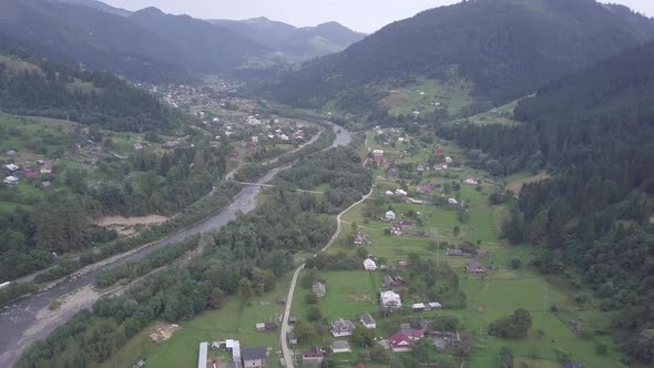 Aerial summer view to Carpathian village Kryvorivnia amidst mountains