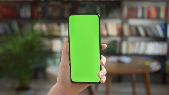 Back View of Woman at Phone with Green Screen for Copy Space alt