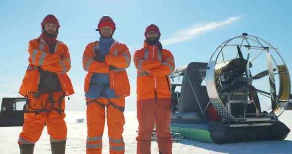 Coast Guard Team with Arms Crossed Posing at Camera Over Frozen Lake