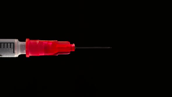 Drop On The End Of Needle Of A Syringe - Side View