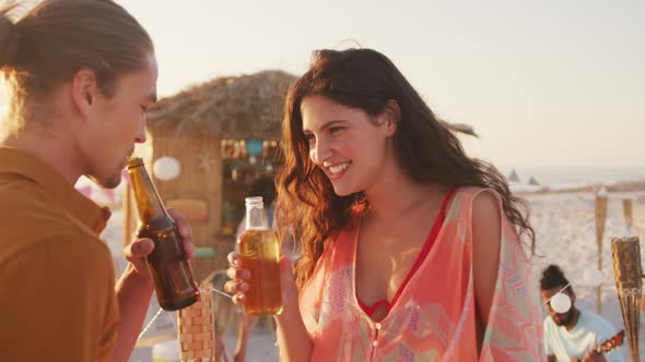 Caucasian friends enjoying a party on the beach