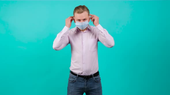 Handsome Man Puts on a Mask on His Face From Air Pollution and Coronavirus