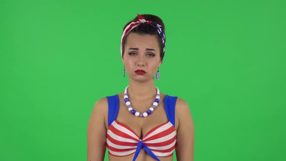 Portrait of Beautiful Upset Girl in a Swimsuit Is Shrugging. Green Screen