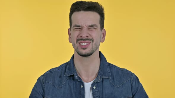 Portrait of Angry Young Man Screaming, Yellow Background