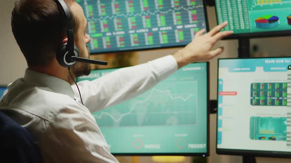 Broker with Headphones Checking the Stock Market