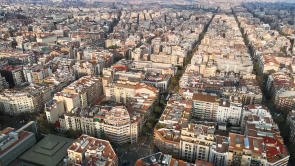 Aerial drone view of Barcelona, Spain. Blocks with multiple residential buildings, roads with cars