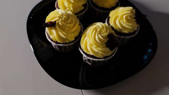 Muffins with Yellow Bright Cheese Cream Close Up Handmade Baking Concept