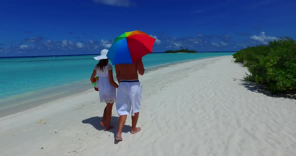 Young couple on honeymoon vacation have fun on beach on summer white sandy background