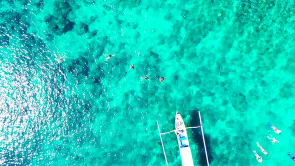 A group of tourists exploring the beautiful coral reefs in the crystal clear waters of a tropical is