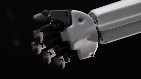 Robot's Hand Moves His Fingers. Black Background . Close Up