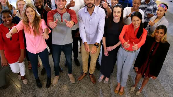 Portrait of business team gesturing together in office