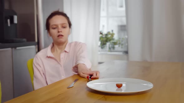 Anorexic Woman Feels Dizzy Depleted By Severe Diet Trying To Eat Tomato