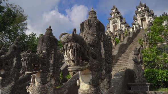 Slowmotion Handheld Shot of Stone Dragons Guarding the Stairs in the Pura Lempuyang Temple at the