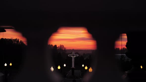 A Christian Cross Against the Backdrop of a Beautiful Red Sunset