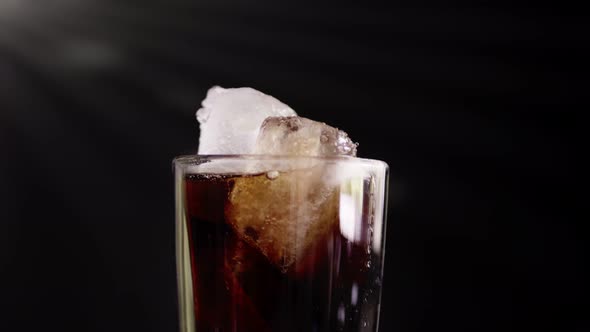 A showcase of the rotation cola with ice close up for a very large glass of cold with slow motion ro