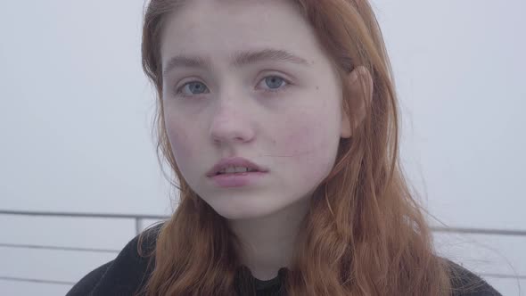 Close Up Portrait of Young Redhead Pretty Woman Posing and Smiling t in Cold Autumn Weather Standing