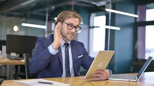 Businessman Talking for Video Chat on Tablet