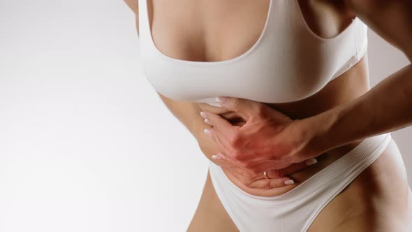 Woman Touching Her Stomach Because of Stomach Pain