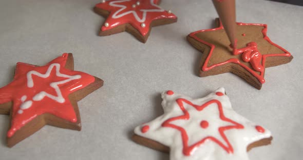 Decoration process of Christmas cookies. Close up of gingerbread star