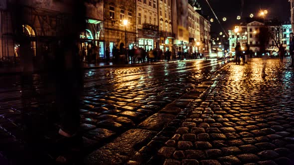 Timelapse Movement of People at Night City Street with Lights. Cobblestone Road. Tourism and Travel