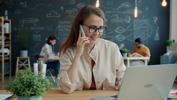 Slow Motion of Young Lady Office Worker Talking on Mobile Phone in Open Space Room