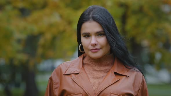 Female Portrait Closeup Young Attractive Overweight Hispanic Woman Staring Intent at Camera Standing