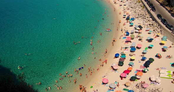 Colorful View from Cliff on Beach with persons - slow motion