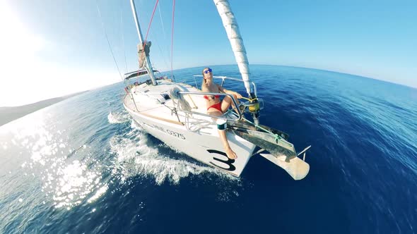 Drifting Vessel with a Lady Sitting on Its Prow and Filming Herself