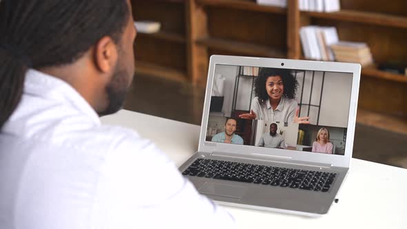 An AfricanAmerican Male Office Employee Using a Laptop for Video Meeting
