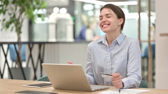 Successful Online Payment on Laptop By Young Woman in Office 