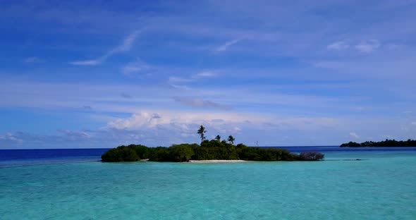 Tropical aerial tourism shot of a sunshine white sandy paradise beach and aqua blue water background