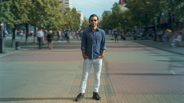 Time Lapse of Stylish Mixed Race Man Standing Outdoors in City Street on Warm Sunny Day