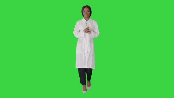 Young African American Female Doctor Talking As She Walks on a Green Screen, Chroma Key.