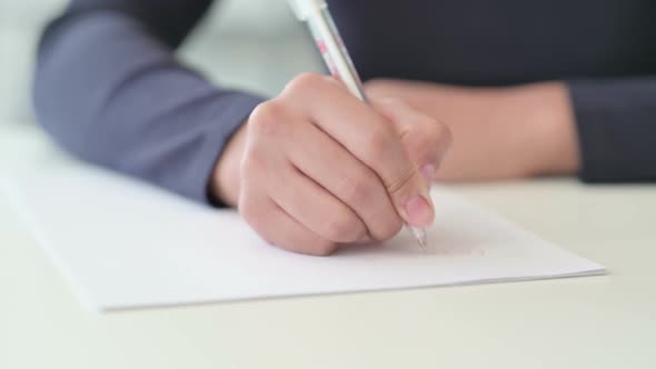 Close Up of African Woman Writing on Paper