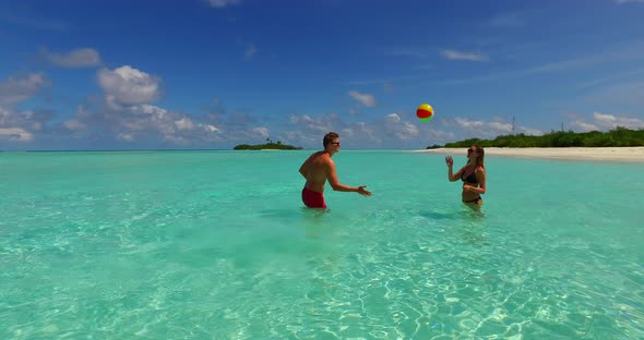 Young couple in love dating on vacation enjoy luxury on beach on white sand background 4K