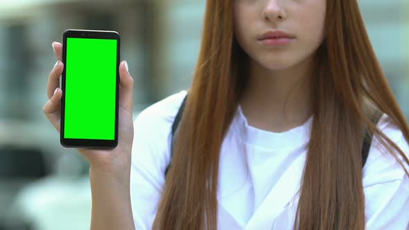 Sad High School Pupil Holding Green Screen Smartphone, Cyber Bullying Problem