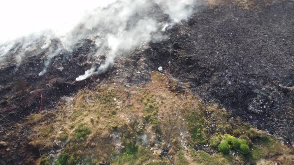 Aerial view hose use to spray water at fire burning