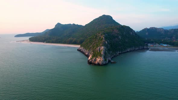 4K aerial view of mountain coast near beautiful beach and sea. Flight over sea.